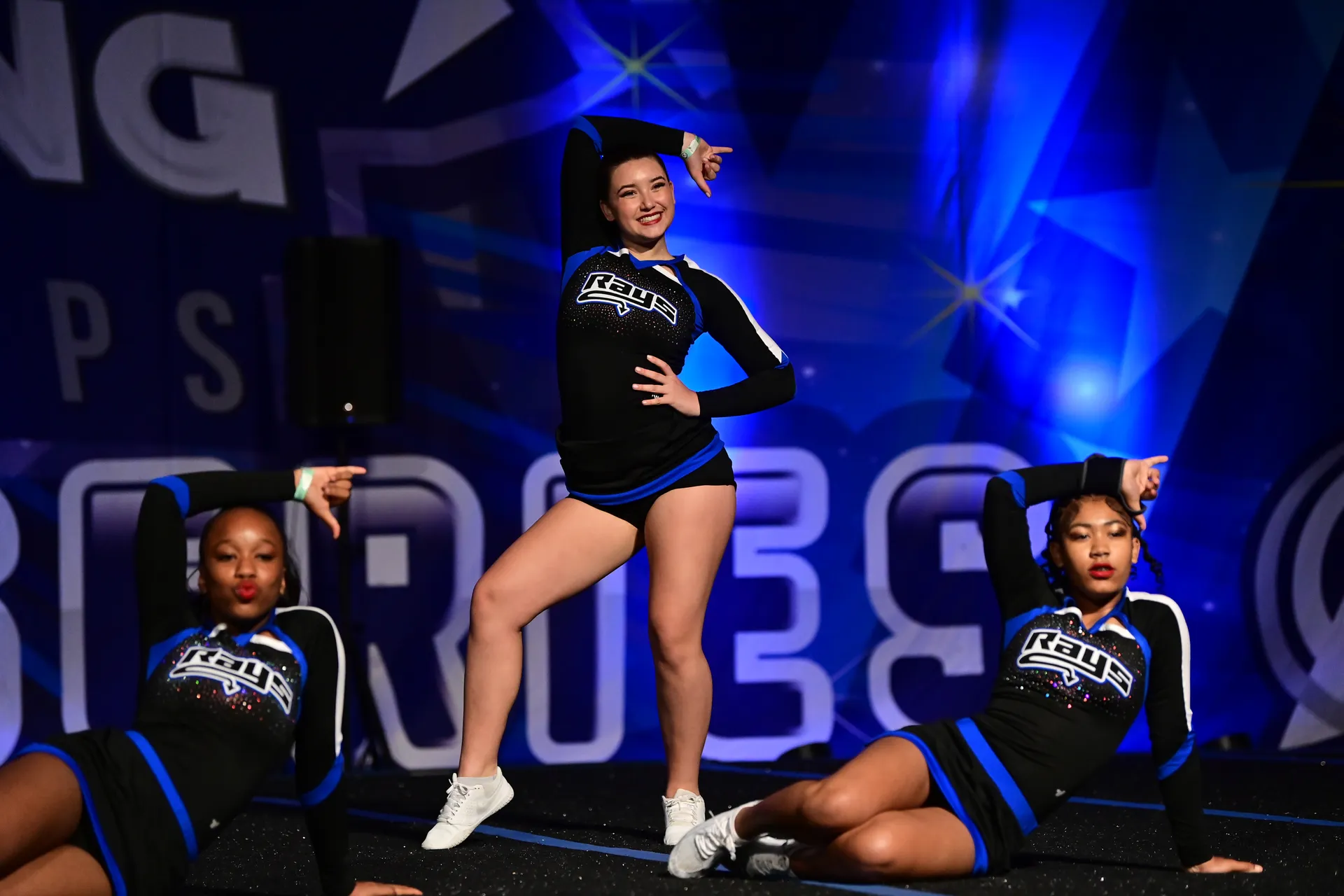 Stingray half-year cheer athletes performing together in black competition uniforms